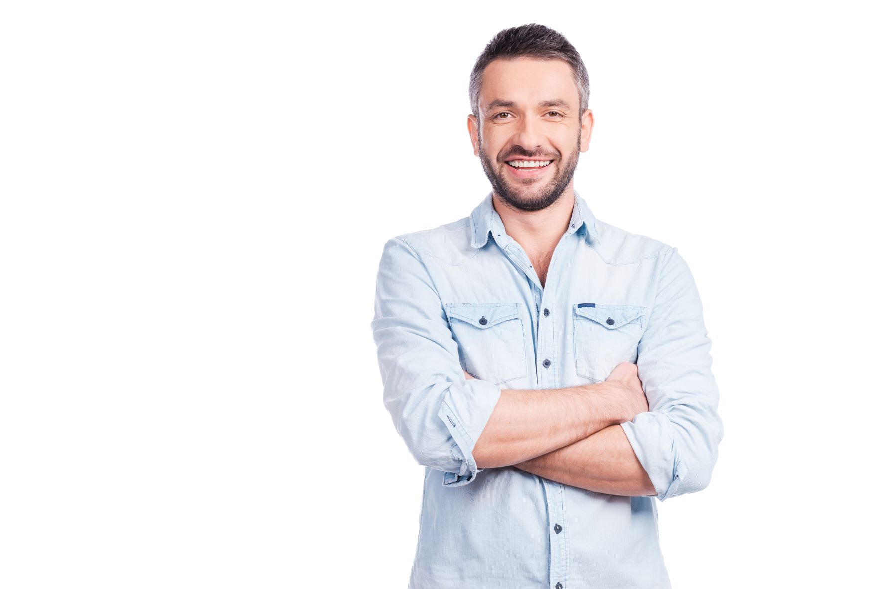 Smiling man standing in front of white background arms crossed